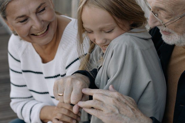 two grandparents with child